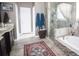 Bathroom with a bathtub and glass enclosed shower; with tile flooring at 29650 Eagle Station Dr, Wesley Chapel, FL 33543