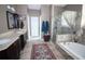 Bathroom showcasing double vanity sinks, walk-in shower, and soaking tub at 29650 Eagle Station Dr, Wesley Chapel, FL 33543