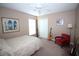 Bedroom features a ceiling fan, a bed, and eclectic decor with natural light from the window at 29650 Eagle Station Dr, Wesley Chapel, FL 33543