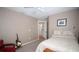 Bedroom features a ceiling fan, a bed, and eclectic decor with natural light from the window at 29650 Eagle Station Dr, Wesley Chapel, FL 33543