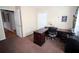 Versatile bedroom features a dark desk with plenty of storage and neutral decor at 29650 Eagle Station Dr, Wesley Chapel, FL 33543
