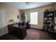 Simple bedroom with a large window, a dark wood desk and two dark brown bookshelves at 29650 Eagle Station Dr, Wesley Chapel, FL 33543