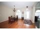 Dining room featuring wood floors, chandelier, arched doorways, and natural light at 29650 Eagle Station Dr, Wesley Chapel, FL 33543