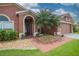 Inviting front entrance with brick walkway, stone landscaping, and well maintained lawn at 29650 Eagle Station Dr, Wesley Chapel, FL 33543