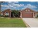 Charming single-story home with manicured lawn, brick walkway, and two-car garage at 29650 Eagle Station Dr, Wesley Chapel, FL 33543