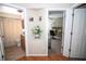Hallway featuring an open bathroom and a bedroom with a large desk at 29650 Eagle Station Dr, Wesley Chapel, FL 33543
