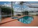 Backyard featuring a screened-in pool and spa at 29650 Eagle Station Dr, Wesley Chapel, FL 33543