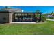 Outdoor patio featuring neutral furniture, sliding glass doors, and green lawn at 301 Windrush Loop, Tarpon Springs, FL 34689