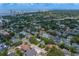 A view from above of a vibrant neighborhood with homes surrounded by trees and a distant skyline at 3404 W Leona St, Tampa, FL 33629