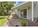 Charming back porch with bench seating, potted plants, and sliding glass door to the house at 3404 W Leona St, Tampa, FL 33629