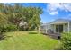 Expansive backyard featuring a well-maintained lawn and a small wooden deck at 3404 W Leona St, Tampa, FL 33629