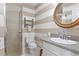 Well-lit bathroom featuring a glass shower, oval mirror, and modern fixtures at 3404 W Leona St, Tampa, FL 33629