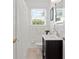 Bright bathroom features a dark vanity and white fixtures at 3404 W Leona St, Tampa, FL 33629