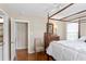 Traditional bedroom with a four poster bed and ensuite bath at 3404 W Leona St, Tampa, FL 33629