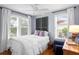 Bright bedroom with a white comforter, soft colors, and lots of natural light at 3404 W Leona St, Tampa, FL 33629