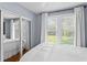 Bright bedroom features a mirrored closet and three windows at 3404 W Leona St, Tampa, FL 33629
