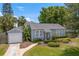 Charming home with well-kept lawn, landscaping, and a detached garage adding to its curb appeal at 3404 W Leona St, Tampa, FL 33629