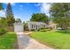 Quaint single-Gathering home with a detached garage and beautiful green lawn at 3404 W Leona St, Tampa, FL 33629