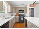 Updated kitchen featuring stainless steel appliances, gray cabinets, and bright white countertops at 3404 W Leona St, Tampa, FL 33629