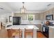 Stylish kitchen featuring quartz countertops, an island, and stainless steel appliances at 3404 W Leona St, Tampa, FL 33629