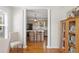 Open-concept living space with decorative columns and a view into the kitchen at 3404 W Leona St, Tampa, FL 33629