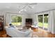 Sunlit living room with hardwood floors and backyard access through sliding glass doors at 3404 W Leona St, Tampa, FL 33629