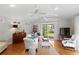 Bright living room with hardwood floors and sliding glass doors leading to the backyard at 3404 W Leona St, Tampa, FL 33629