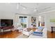 Spacious living room with hardwood floors, three ceiling fans, and backyard access at 3404 W Leona St, Tampa, FL 33629