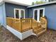 New backyard deck with wooden railings, stairs, and decorative lighting is perfect for outdoor entertaining at 3718 N 36Th St, Tampa, FL 33610