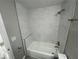 Clean bathroom features a tile-surround tub, shower, and neutral color palette at 3718 N 36Th St, Tampa, FL 33610