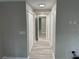 Bright hallway with gray walls, white trim, updated light fixtures, and wood-look flooring at 3718 N 36Th St, Tampa, FL 33610