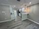 Modern kitchen featuring white cabinets, stainless steel appliances, and trendy gray wood-look flooring at 3718 N 36Th St, Tampa, FL 33610