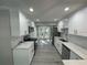 Bright, modern kitchen with white cabinets, stainless steel appliances, and quartz countertops at 3718 N 36Th St, Tampa, FL 33610