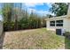 Backyard view features tall bamboo and partial grass coverage, with the home's AC unit visible at 3919 W Paxton Ave, Tampa, FL 33611