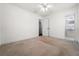 Cozy bedroom with neutral carpet and adjacent bathroom access at 3919 W Paxton Ave, Tampa, FL 33611