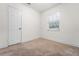 Neutral bedroom with carpet, window, and closet, offering a calming atmosphere at 3919 W Paxton Ave, Tampa, FL 33611