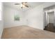 Comfortable bedroom with carpet, ceiling fan, and natural light at 3919 W Paxton Ave, Tampa, FL 33611