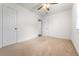 Bedroom with neutral carpet, ceiling fan, and closet at 3919 W Paxton Ave, Tampa, FL 33611