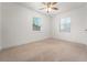 Bedroom featuring neutral carpet, ceiling fan, and natural light at 3919 W Paxton Ave, Tampa, FL 33611