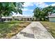Charming single-story home with well-manicured lawn, landscaping, and long driveway at 3919 W Paxton Ave, Tampa, FL 33611