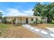 Charming one-story home featuring stone pathway and covered entryway at 3919 W Paxton Ave, Tampa, FL 33611