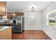Bright eat-in kitchen with stainless steel refrigerator and hardwood floors at 3919 W Paxton Ave, Tampa, FL 33611