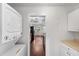 Convenient laundry area with stackable washer and dryer near kitchen with hardwood floors at 3919 W Paxton Ave, Tampa, FL 33611
