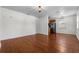 Spacious living room with hardwood floors, neutral walls, and an adjacent kitchen at 3919 W Paxton Ave, Tampa, FL 33611