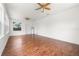 Open living room with hardwood floors, ceiling fans, and multiple entryways at 3919 W Paxton Ave, Tampa, FL 33611