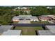 An aerial view showing the layout of the property with carports, landscaping, and a glimpse of the surrounding neighborhood at 4039 La Pasida Ln, New Port Richey, FL 34655