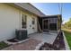 Home exterior with brick paver detail, patio, AC unit, and screened sunroom at 4039 La Pasida Ln, New Port Richey, FL 34655