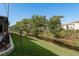 Backyard view of community green space, mature trees and a canal running behind the property at 4039 La Pasida Ln, New Port Richey, FL 34655