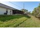 Backyard view of property showing mature trees and a canal at 4039 La Pasida Ln, New Port Richey, FL 34655