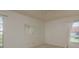 This bedroom features large window, light colored walls and carpet flooring at 4039 La Pasida Ln, New Port Richey, FL 34655